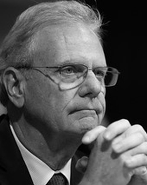 Jim Desmond, hands clasped, listening at a hearing