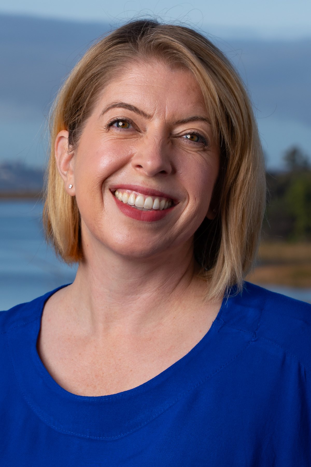 Marni von Wilpert smiling outdoors above a San Diego bay