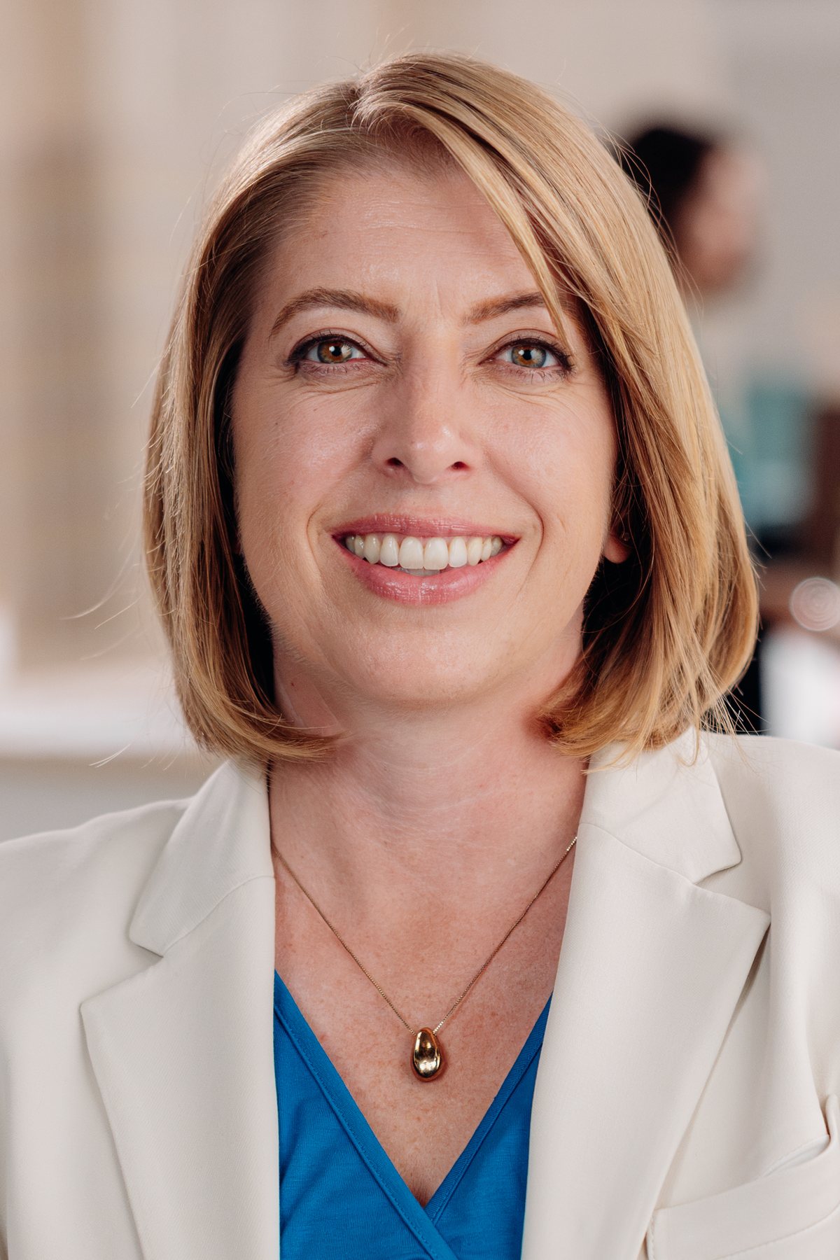 Marni von Wilpert, arms crossed, smiling in a health clinic